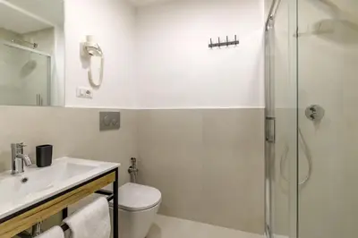 a bathroom with a toilet and a sink and a shower at Remember Vatican Apartment in Rome