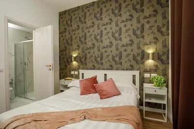 a bedroom with a bed and a stone wall at Remember Vatican Apartment in Rome
