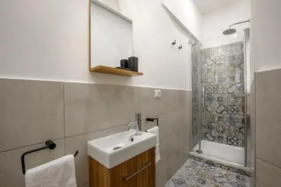 a bathroom with a sink and a shower at Remember Vatican Apartment in Rome