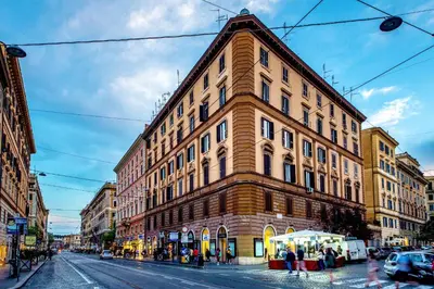a large building on a city street with people walking around at Remember Vatican Apartment in Rome