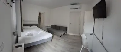 a small bedroom with a bed and a couch at Gemelli BnB Guest House in Rome