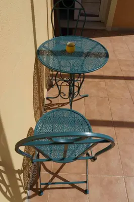 a blue table and chairs with a cup on top at Gemelli BnB Guest House in Rome