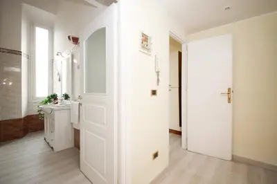 a bathroom with a white door and a sink at Rafael House by GHOR in Rome