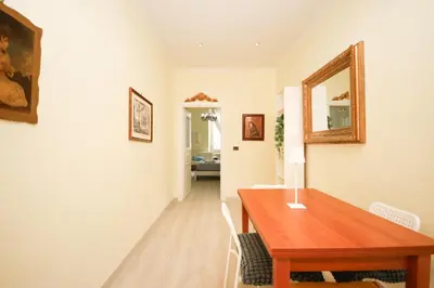 a dining room with a table and a mirror on the wall at Rafael House by GHOR in Rome