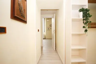 a hallway of a house with white walls and white shelves at Rafael House by GHOR in Rome