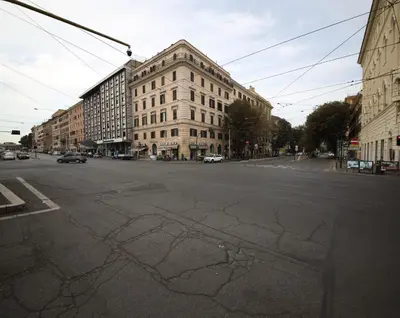 an empty city street with a large building at Rafael House by GHOR in Rome
