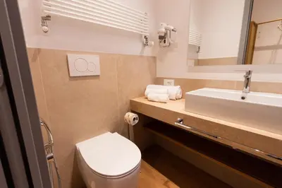 a bathroom with a toilet and a sink at Trevi Monti House in Rome