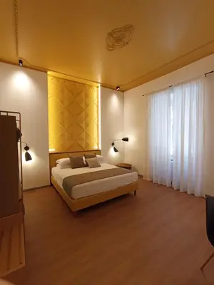 a bedroom with a bed and a large window at Trevi Monti House in Rome
