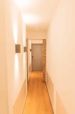 a hallway with white walls and a door at Trevi Monti House in Rome