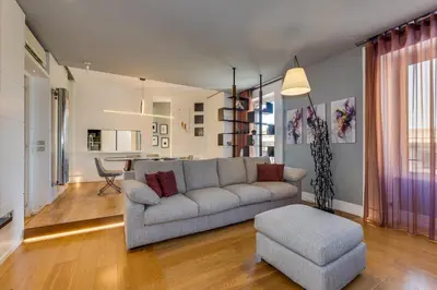 a living room with a couch and a chair at Belli Vatican Attico - Luxury Design Rooftop Apartment close to Vatican City in Rome