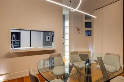 a dining room with a glass table and chairs at Belli Vatican Attico - Luxury Design Rooftop Apartment close to Vatican City in Rome