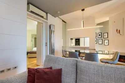 a living room with a couch and a table at Belli Vatican Attico - Luxury Design Rooftop Apartment close to Vatican City in Rome