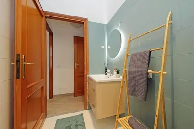 a bathroom with a sink and a mirror at MAYA - Boutique Apartment in Rome