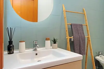 a bathroom with a white sink and a mirror at MAYA - Boutique Apartment in Rome