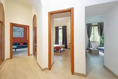 a living room with a hallway with a mirror at MAYA - Boutique Apartment in Rome