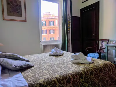 a bedroom with a bed with towels on it at L'Ottavo Re di Roma in Rome