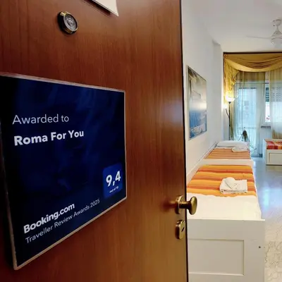 a room with a door with a tv and a bed at Roma For You - Apartment - Metro B in Rome