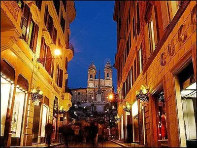 a city street with buildings and a cathedral at night at Piazza di Spagna Luxury Apartment in Rome