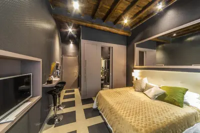 a bedroom with a bed and a television in it at Piazza di Spagna Luxury Apartment in Rome