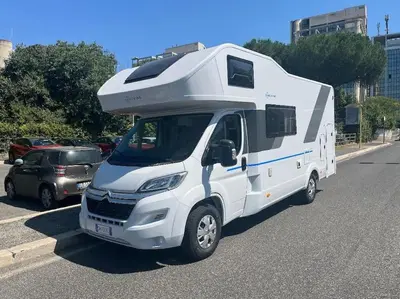 a white camper truck parked in a parking lot at D&D Ardeatino Appia Antica in Rome