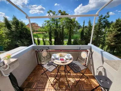 a small balcony with a table and chairs on it at Venus Inn Casa Vacanze AURELIA ANTICA in Rome