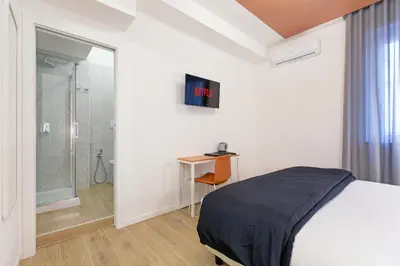 a bedroom with a bed and a walk in shower at Luciano Trastevere Guest House in Rome