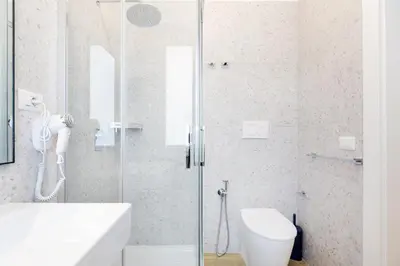a bathroom with a shower with a toilet and a sink at Luciano Trastevere Guest House in Rome