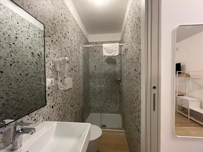 a bathroom with a sink and a shower at Luciano Trastevere Guest House in Rome
