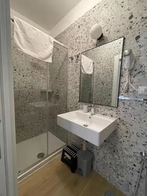 a bathroom with a sink and a shower at Luciano Trastevere Guest House in Rome