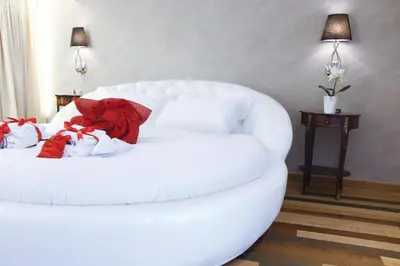 a white couch with red pillows on it in a room at Hub Navona in Rome