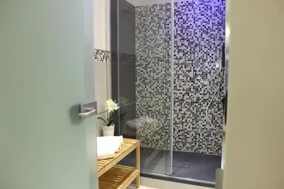 a bathroom with a shower with a glass door at Hub Navona in Rome