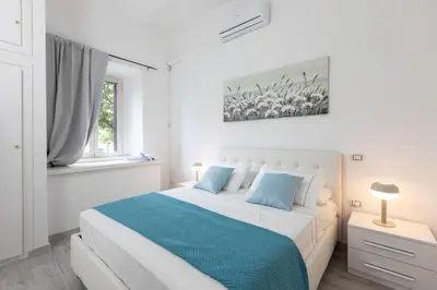 a bedroom with a bed and a painting on the wall at Royal House Pigneto in Rome