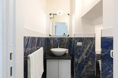 a kitchen with a sink and a washing machine at Royal House Pigneto in Rome