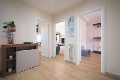 a living room with white walls and wooden floors at San Giovanni Charming Suites in Rome