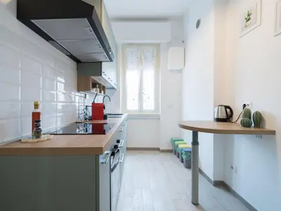 a kitchen with a counter and a table in it at San Giovanni Charming Suites in Rome