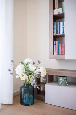 a vase filled with white flowers in a room at San Giovanni Charming Suites in Rome