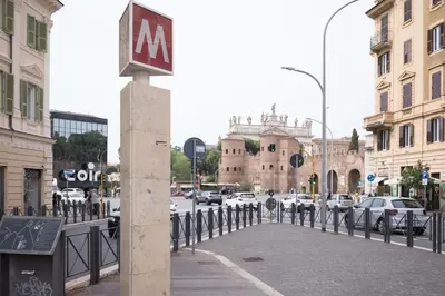 a sign on a pole on a city street at San Giovanni Charming Suites in Rome
