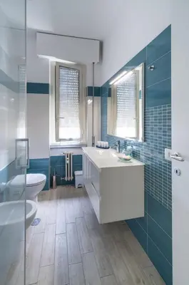 a bathroom with a white sink and a toilet at San Giovanni Charming Suites in Rome