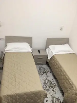 two beds sitting next to each other in a room at Bed&Breakfast MENNA in Rome