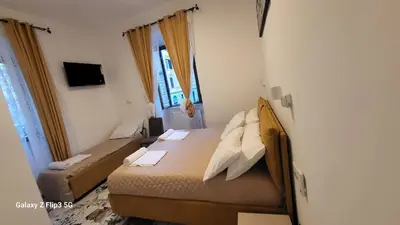 a small bedroom with a bed and a window at Bed&Breakfast MENNA in Rome