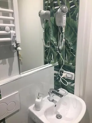 a bathroom with a white sink and a mirror at Bed&Breakfast MENNA in Rome