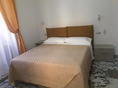 a bed in a small room with a bed sidx sidx sidx at Bed&Breakfast MENNA in Rome