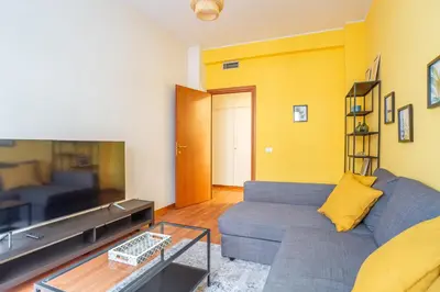 a living room with a couch and a tv at St Peters Colorful 3BDR Apartment in Rome