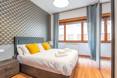 a bedroom with a large bed with yellow pillows at St Peters Colorful 3BDR Apartment in Rome