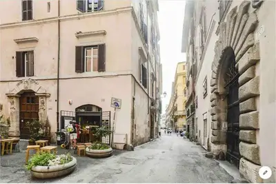 an empty city street with buildings and tables at PANTHEON APARTMENT in the Heart of Rome in Rome