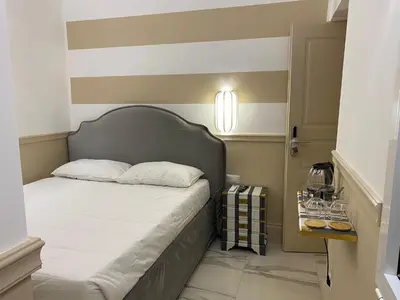a bedroom with a bed with a gray headboard at Cozy Luxury Room Pantheon in Rome