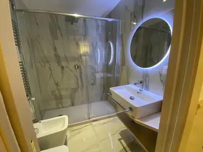 a bathroom with a sink and a shower with a mirror at Cozy Luxury Room Pantheon in Rome