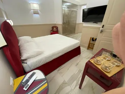 a small bedroom with a bed and a table with a night stand at Cozy Luxury Room Pantheon in Rome