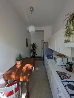a kitchen with a wooden table in the middle at Appartamento della Vittoria in Rome