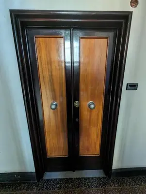 a pair of wooden doors in a room at Appartamento della Vittoria in Rome